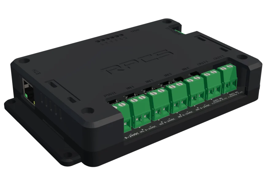 A current RPCS field device: a compact black enclosure, aligned mounting flanges and a row of green terminal blocks seated flush in its opening.